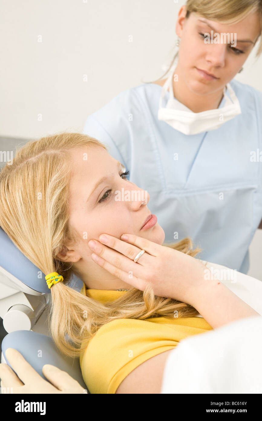 Female dentist and assistant examining patient Stock Photo