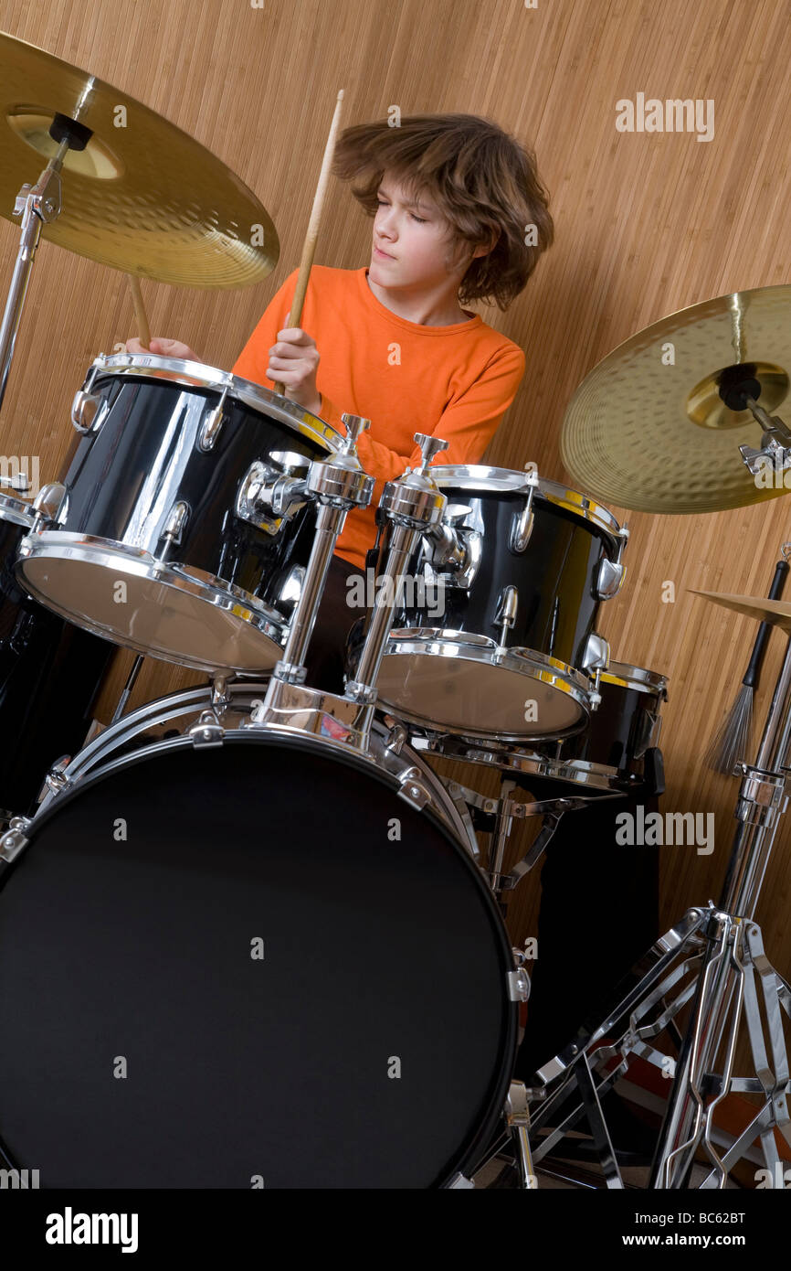 Germany, boy (12-13) playing drums Stock Photo