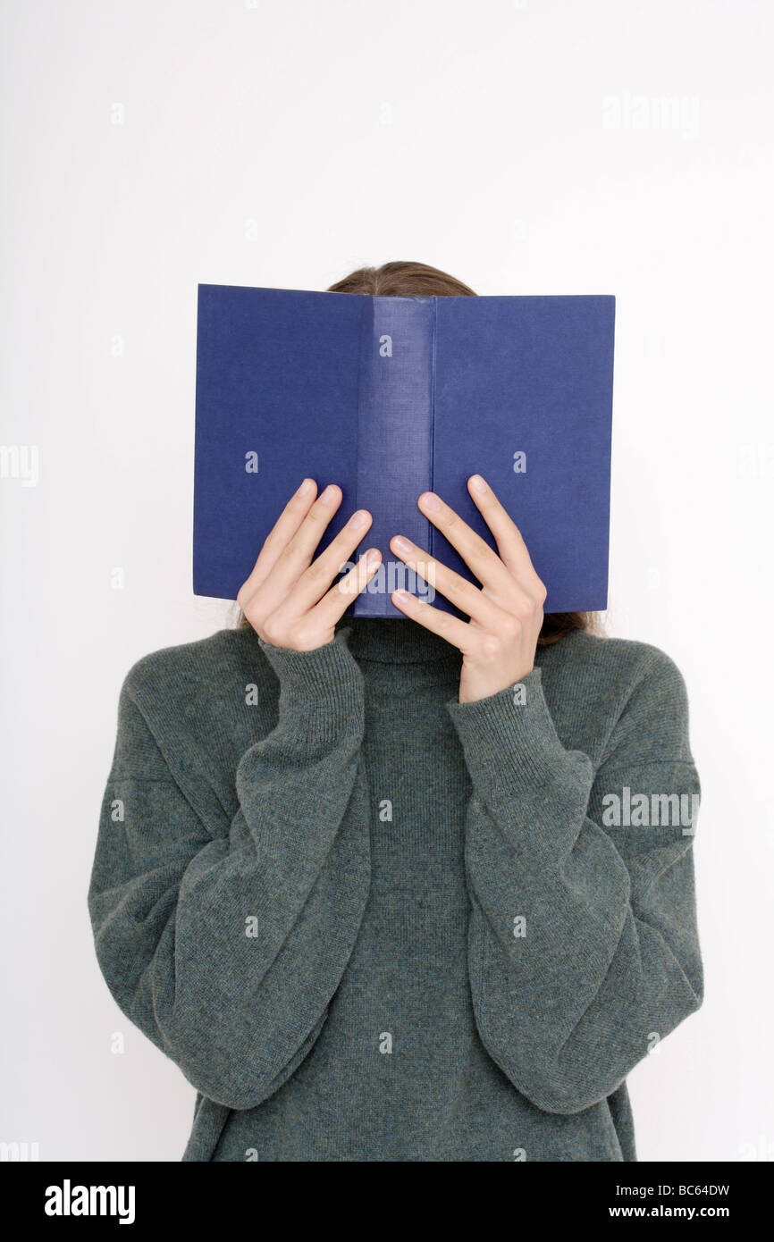 Young woman (16-17) reading book Stock Photo