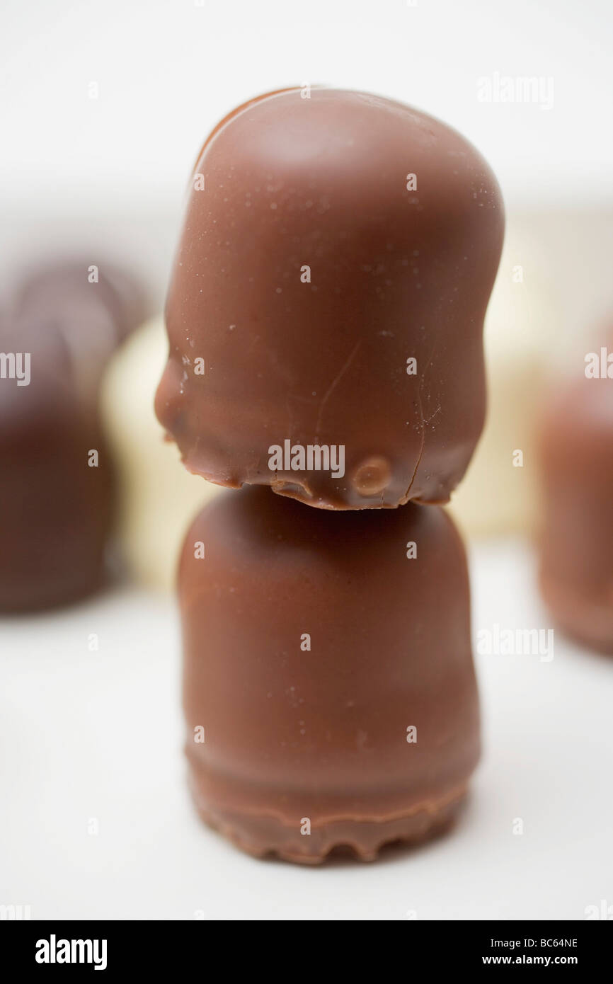 2 chocolatecovered marshmallow wafers, several in background Stock