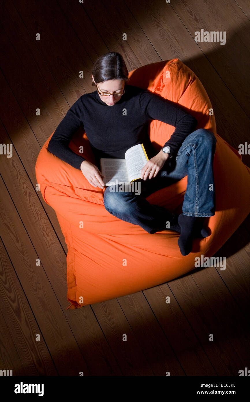 Germany, woman reading book, elevated view Stock Photo