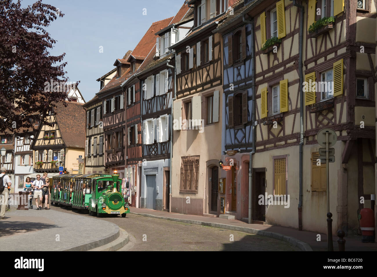 Colmar Alsace France EU Tourist train taking visitors along Quai Poissonnerie on a tour of Little Venice area Stock Photo