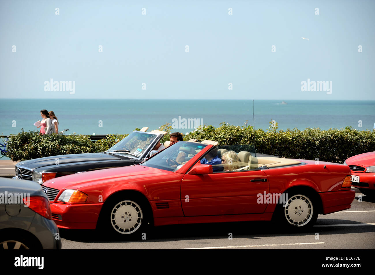 Mercedes convertable cars sitting in traffic along Brighton seafront Stock Photo