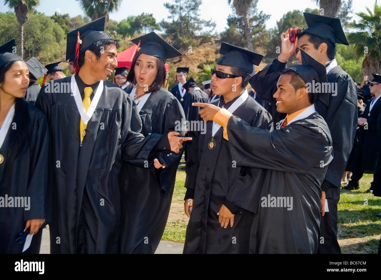 As the audience watches, high school graduates in Costa Mesa, CA, hand in their name cards to be announced as they march to accept their diplomas. Stock Photo