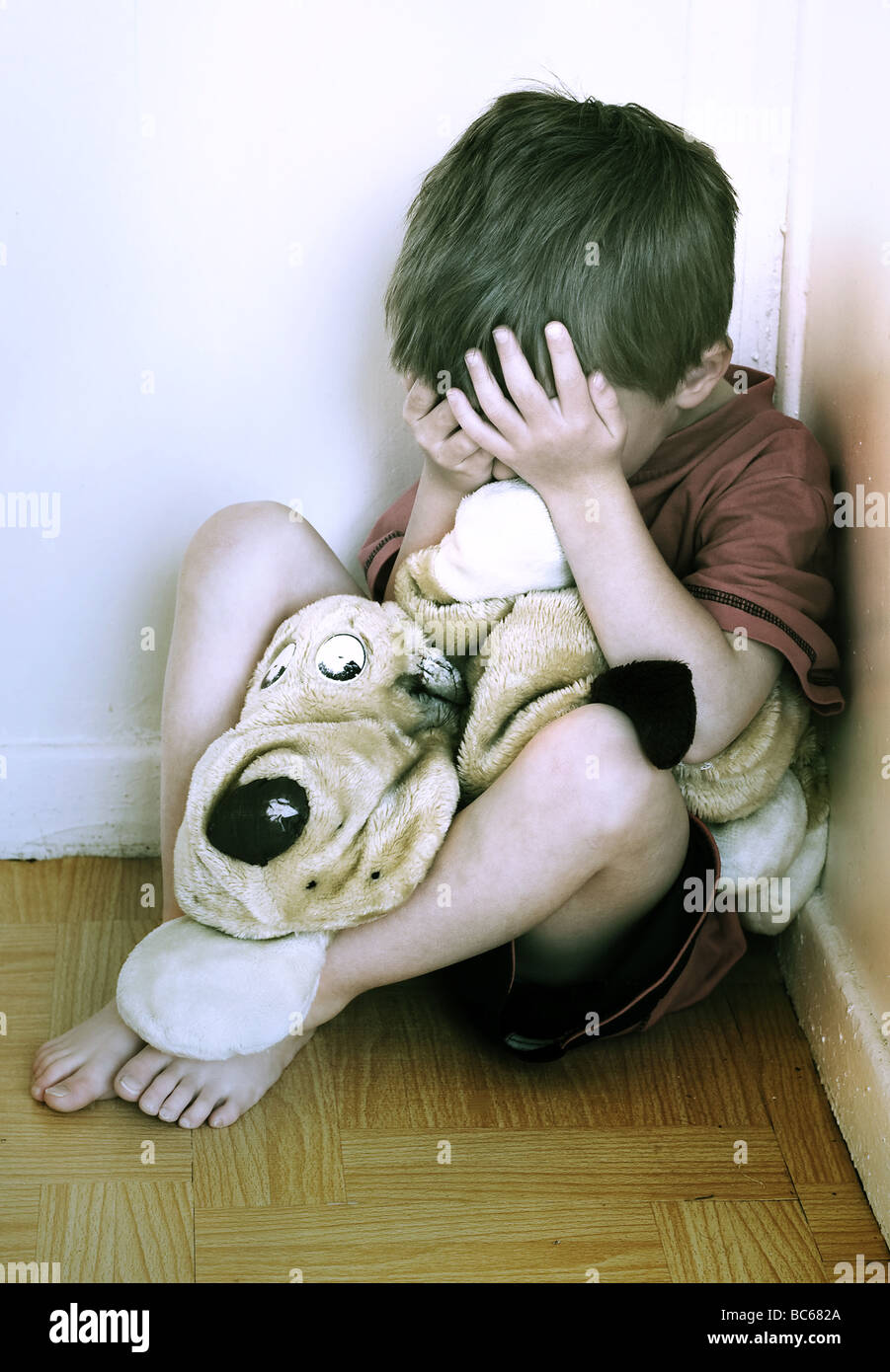 Lonely boy being punished in the corner Stock Photo