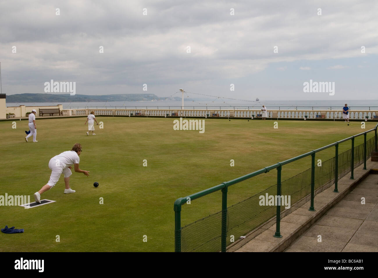 A bowling green set on the coast overlooking Weymouth beach and sea