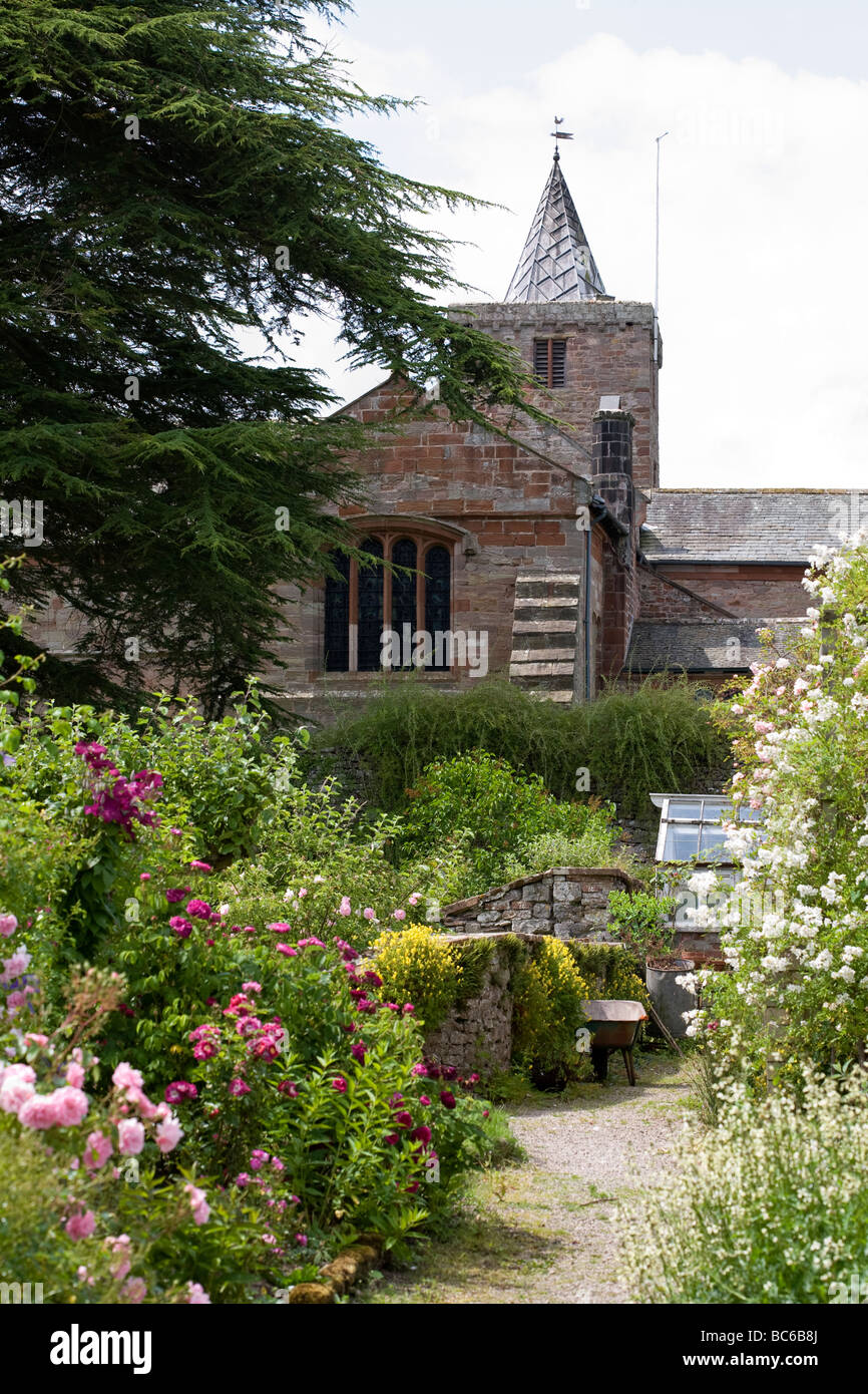 St Laurence Saxon Church beyond traditional English country garden Morland Cumbria UK Stock Photo