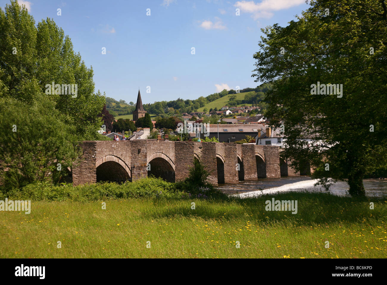 Stone bridge crossing the River Usk in the popular town of Crickhowell Stock Photo