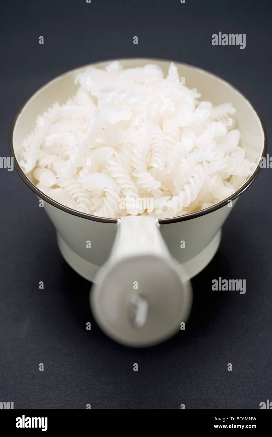 Whole grain corn fusilli in strainer Stock Photo - Alamy