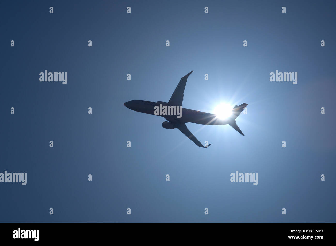 Airliner in silouette of sun Stock Photo
