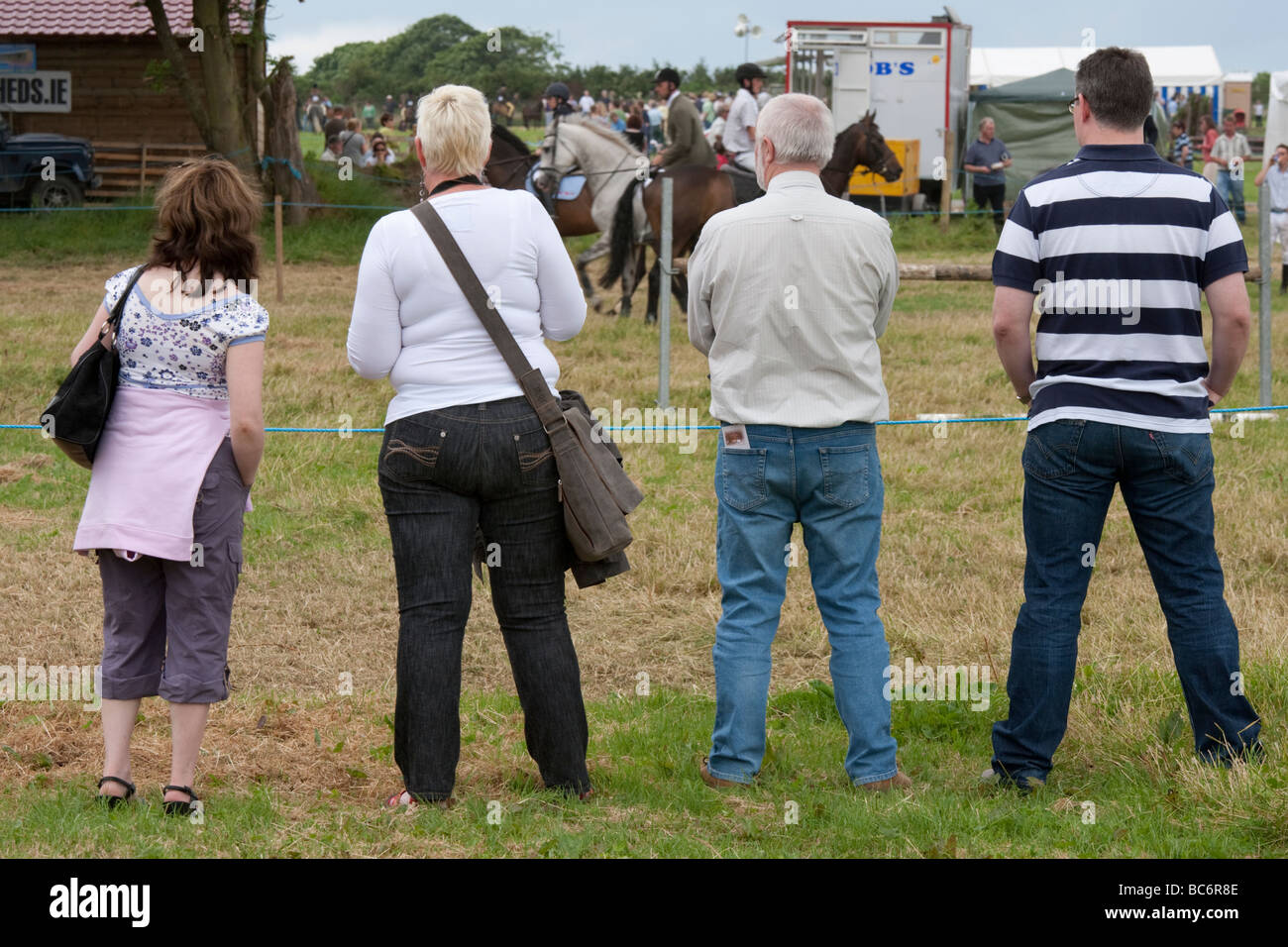 Four people standing in a line Stock Photo