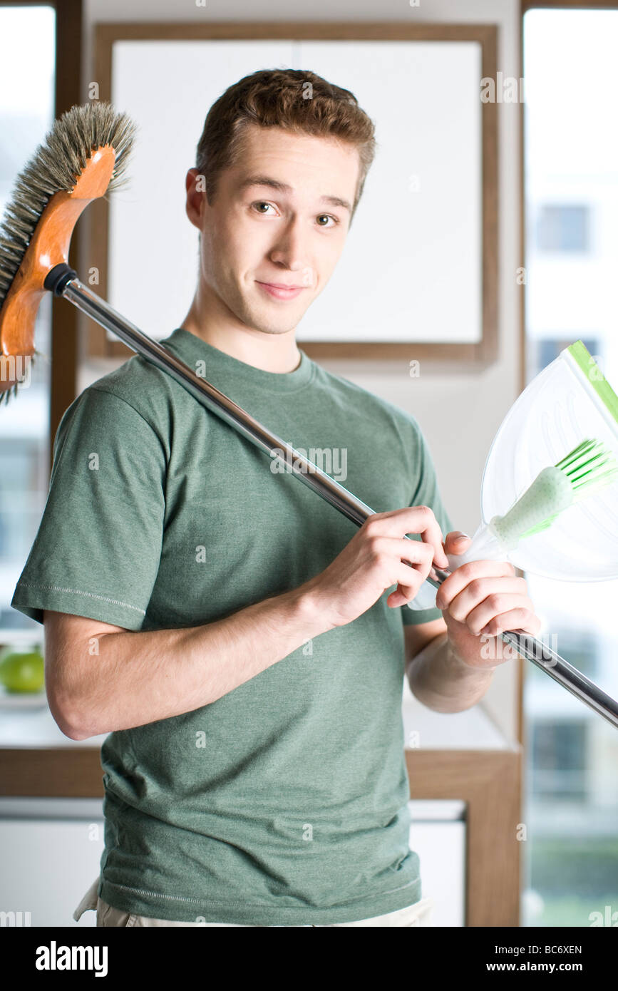 man holding broom Stock Photo Alamy
