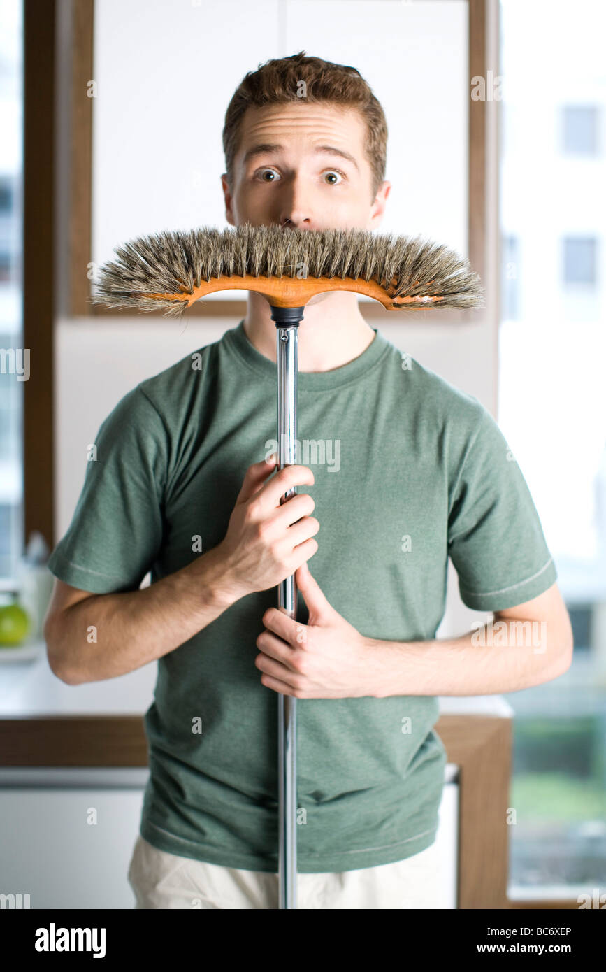 man holding broom Stock Photo Alamy