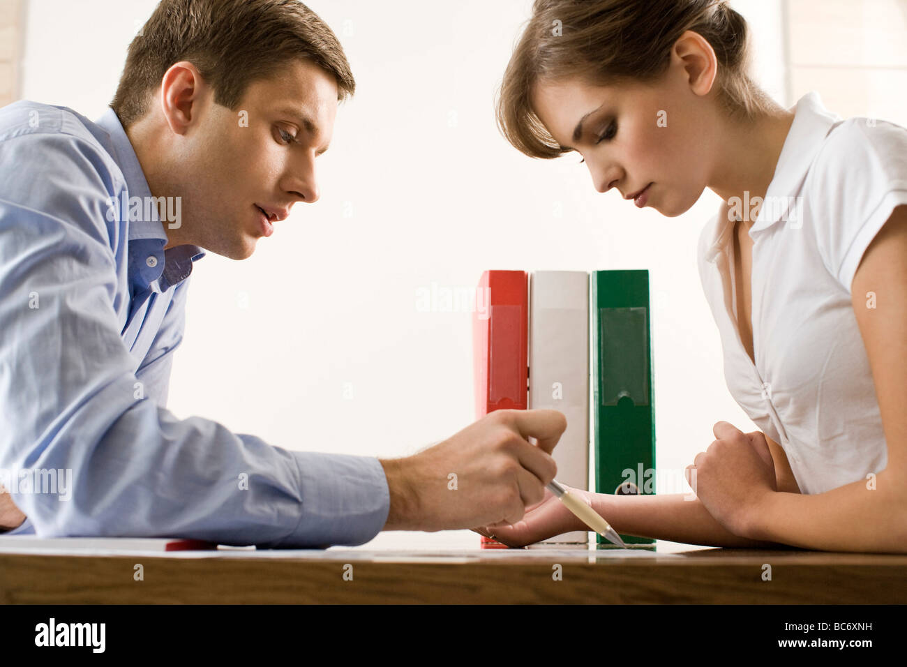 man and woman fill up documents Stock Photo