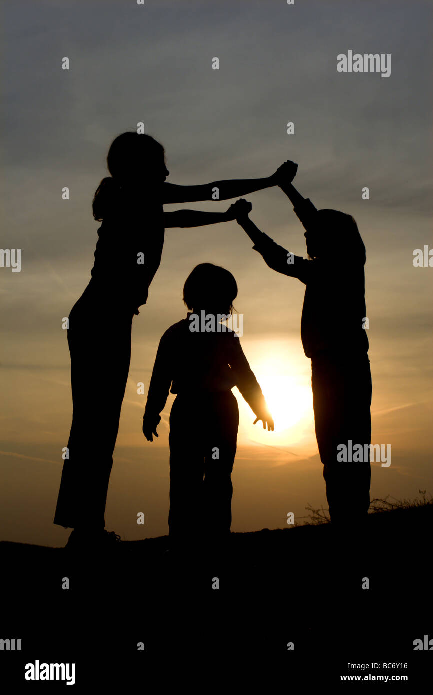 little girls - play in sunset Stock Photo