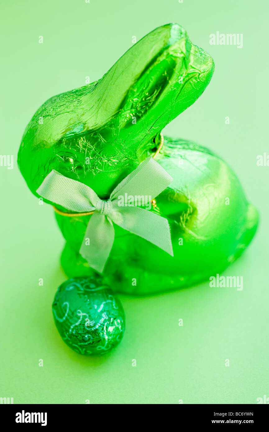Green Easter Bunny and chocolate egg - Stock Photo