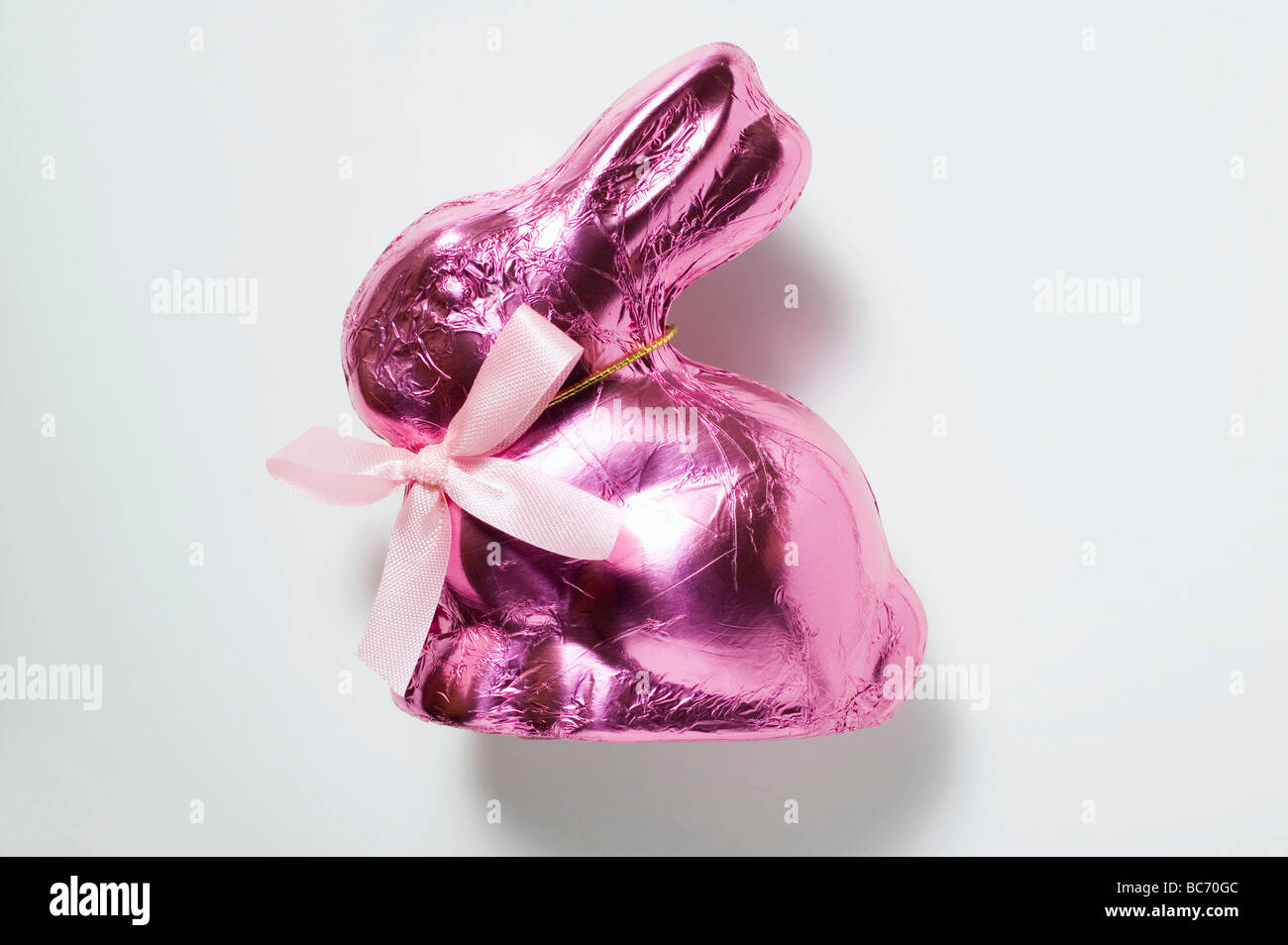 Chocolate bunny in pink foil - Stock Photo