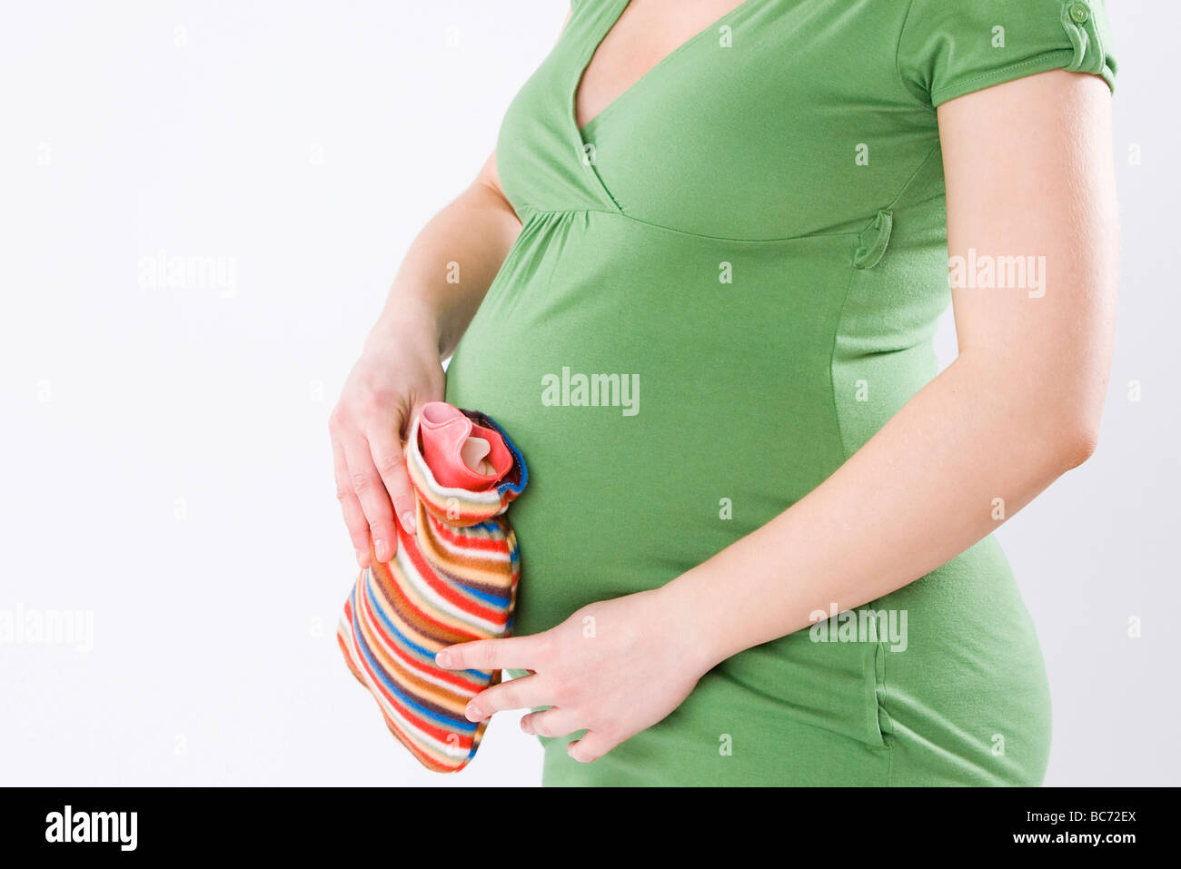 pregnant woman with hot water bottle Stock Photo - Alamy