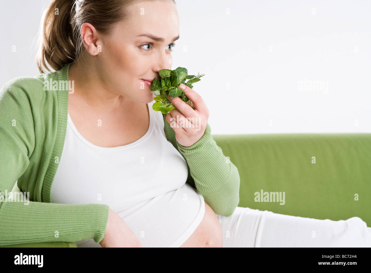 pregnant woman smelling lettuce Stock Photo Alamy