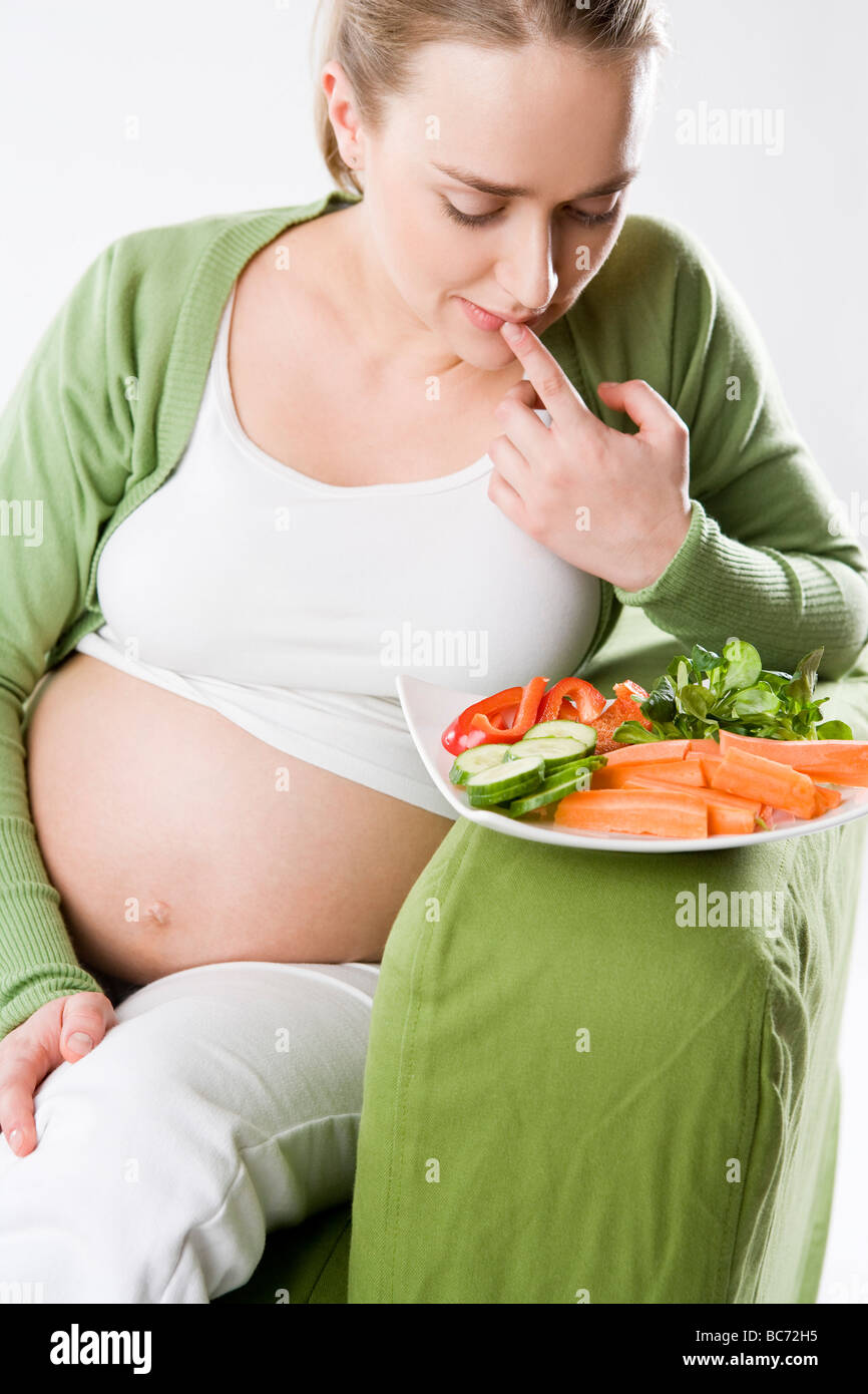 pregnant woman eating vegetables Stock Photo Alamy