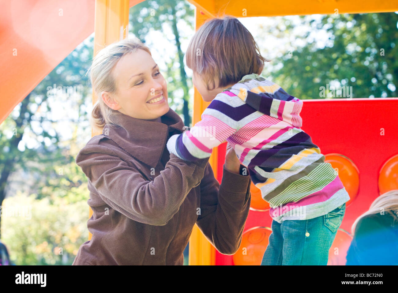 mother and child in playground Stock Photo - Alamy