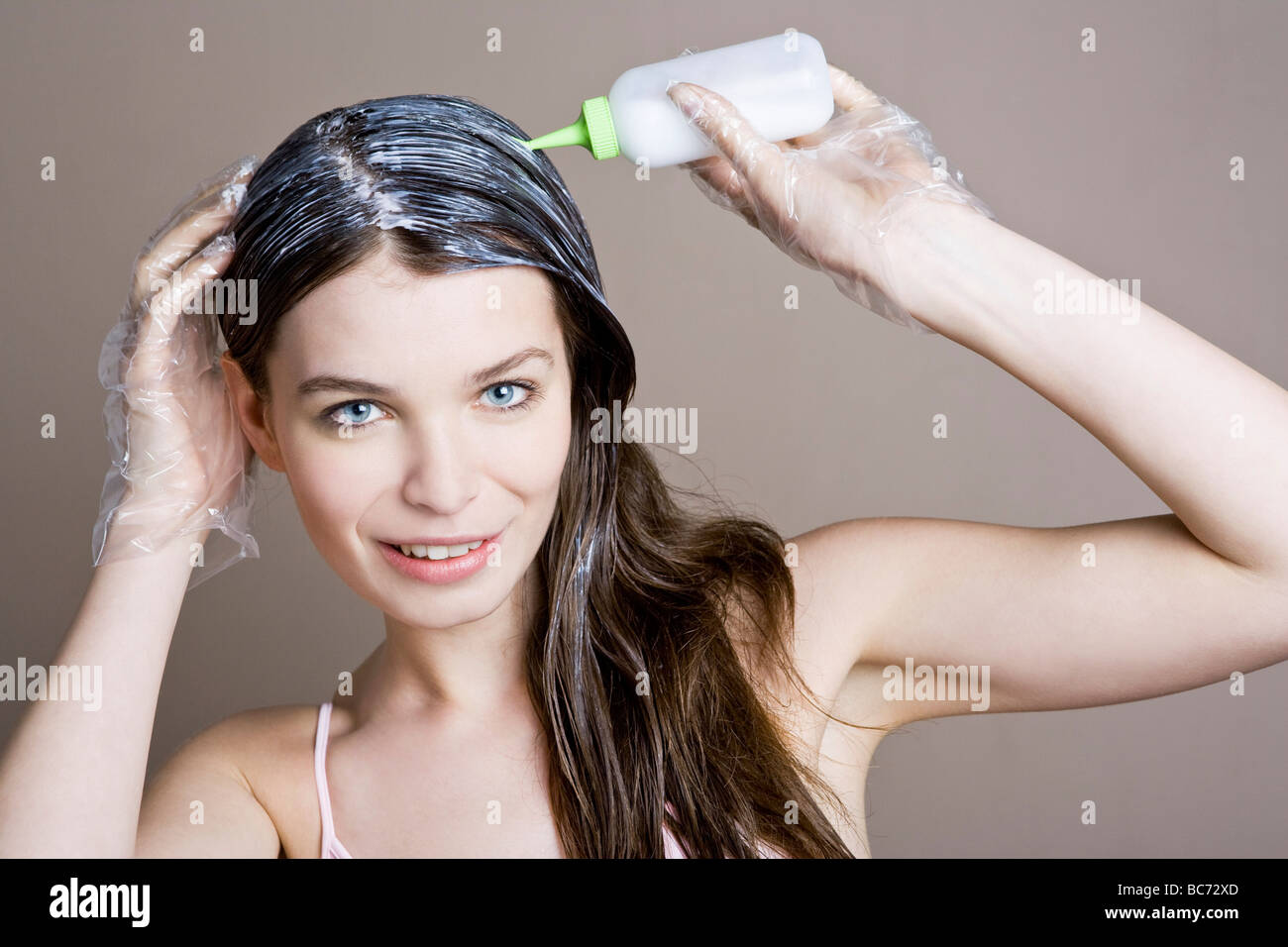 woman applying dye on hair Stock Photo Alamy