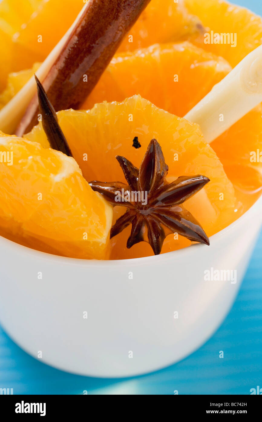 Orange slices with star anise, lemon grass & cinnamon sticks - Stock Photo