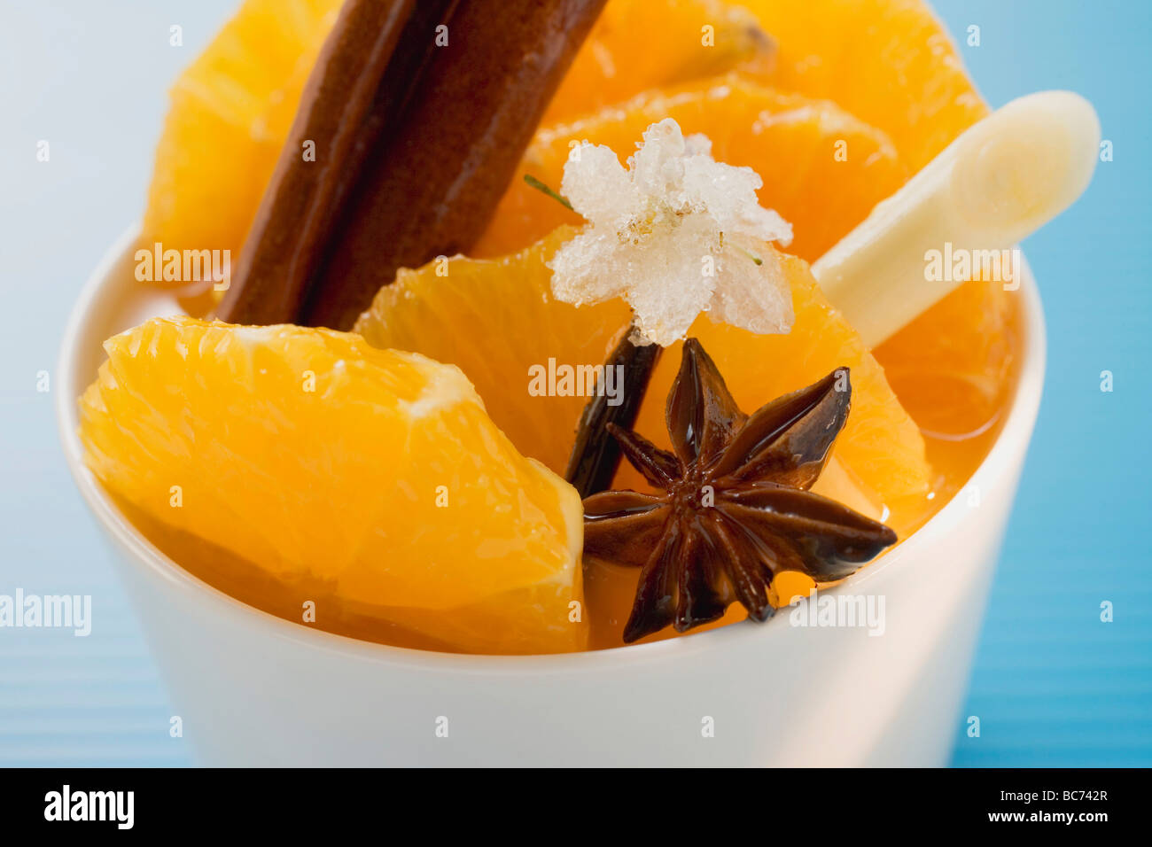 Orange slices with star anise, lemon grass & sugared flower - Stock Photo