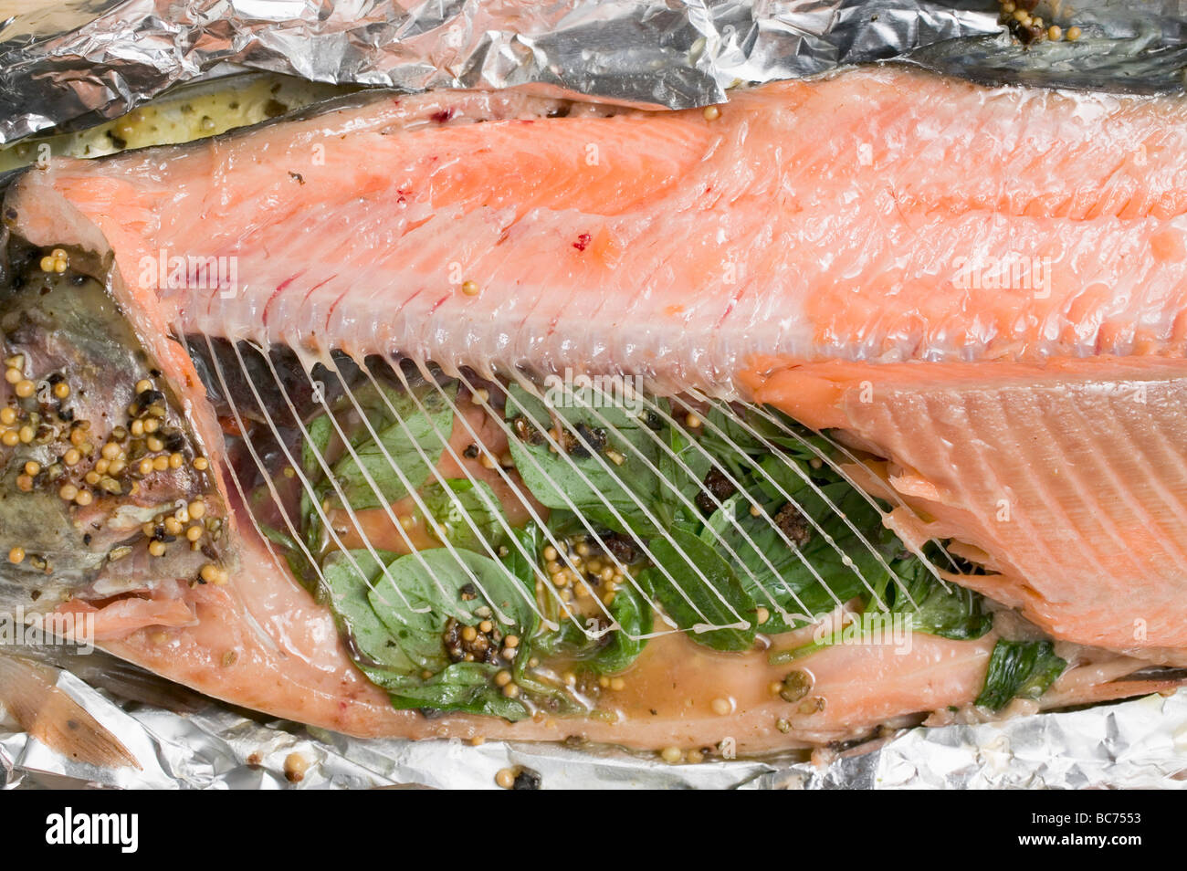 Salmon trout in aluminium foil (detail Stock Photo Alamy