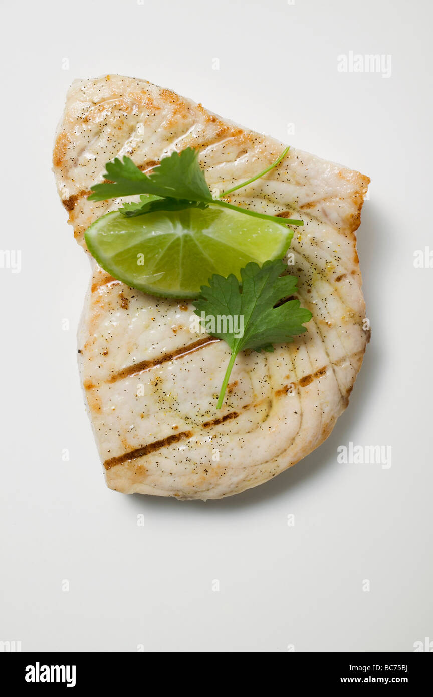 Grilled swordfish steak with lime and coriander leaves Stock Photo Alamy