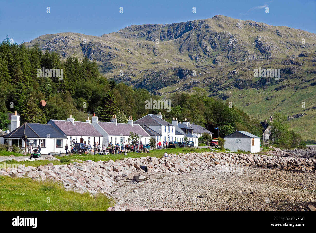 The village of Inverie in Inverie Bay Loch Nevis on Knoydart the West Highlands of Scotland with visitors at The Old Forge Pub Stock Photo