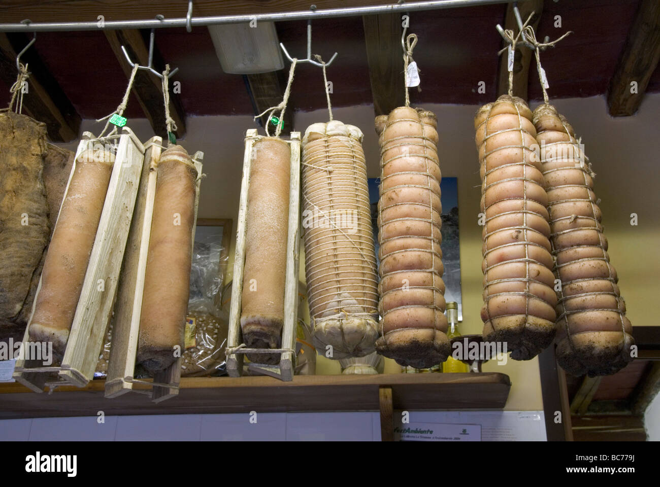 selection of processed meats typical of the Apuane Alps, Carrara and the Lunigiana hanging in a Carrara alimentari Stock Photo