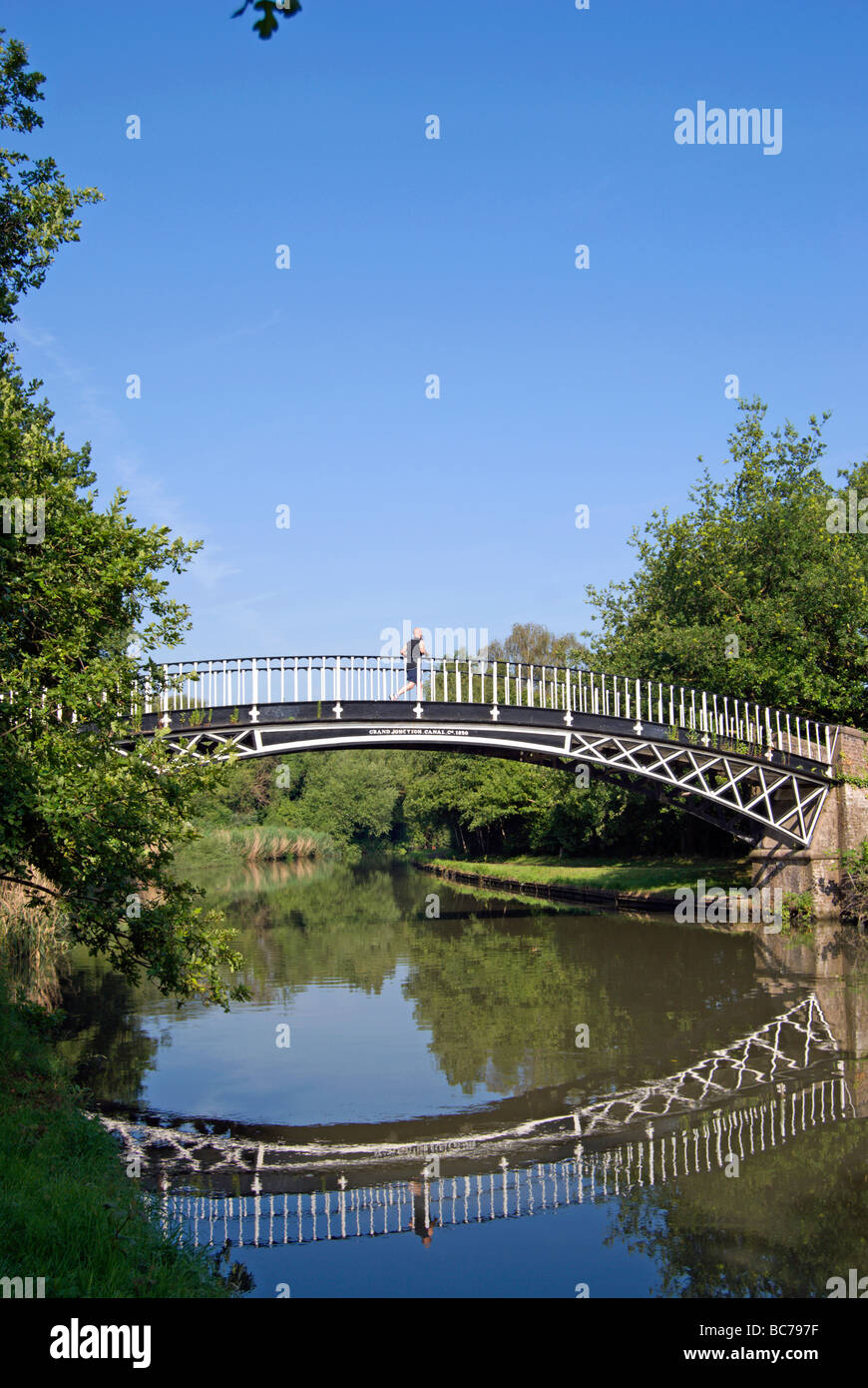 the 1820 gallows bridge crossing the grand union canal, with male jogger in centre, in brentford, west london, england Stock Photo