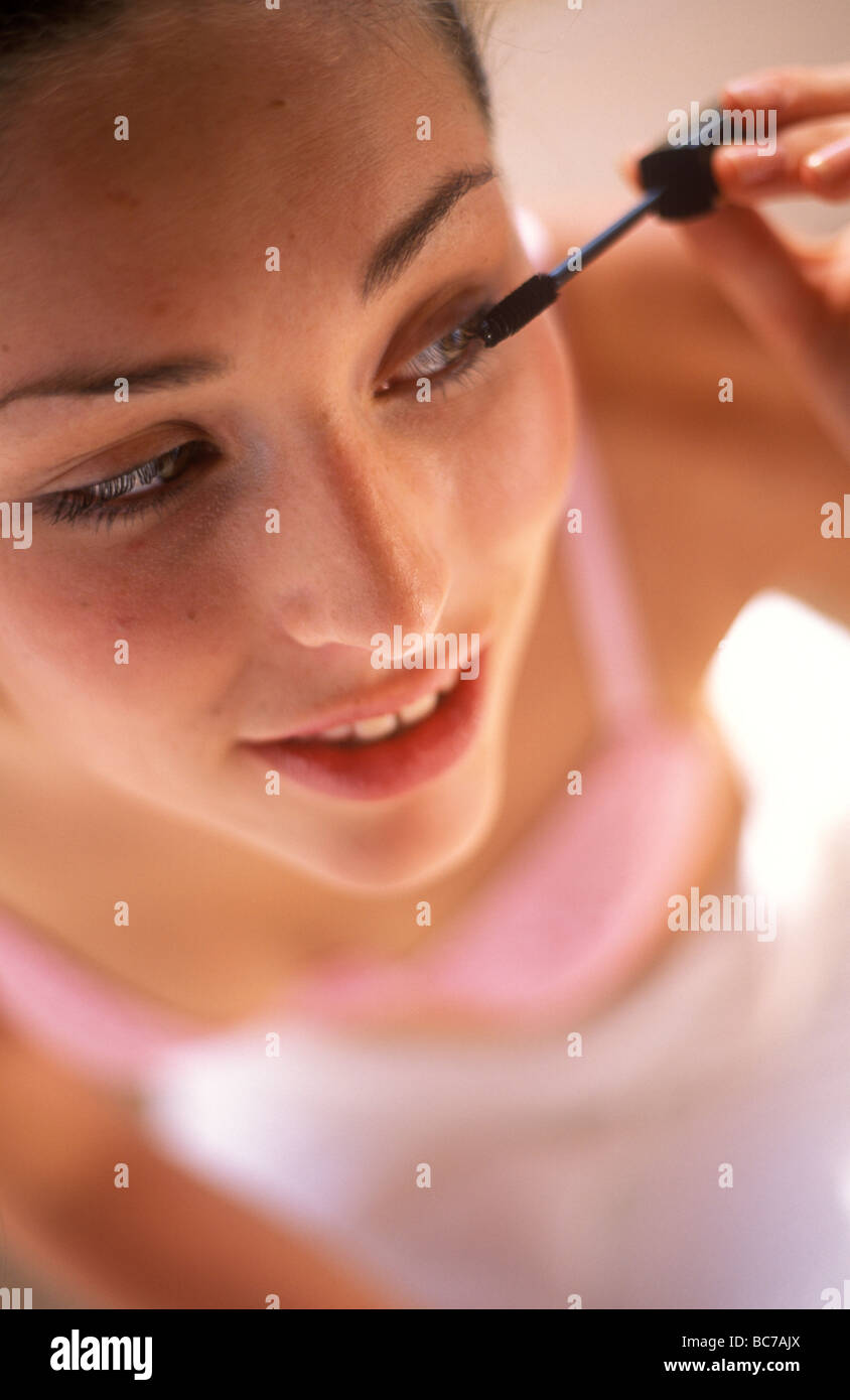 woman applying mascara using a wand applicator Stock Photo