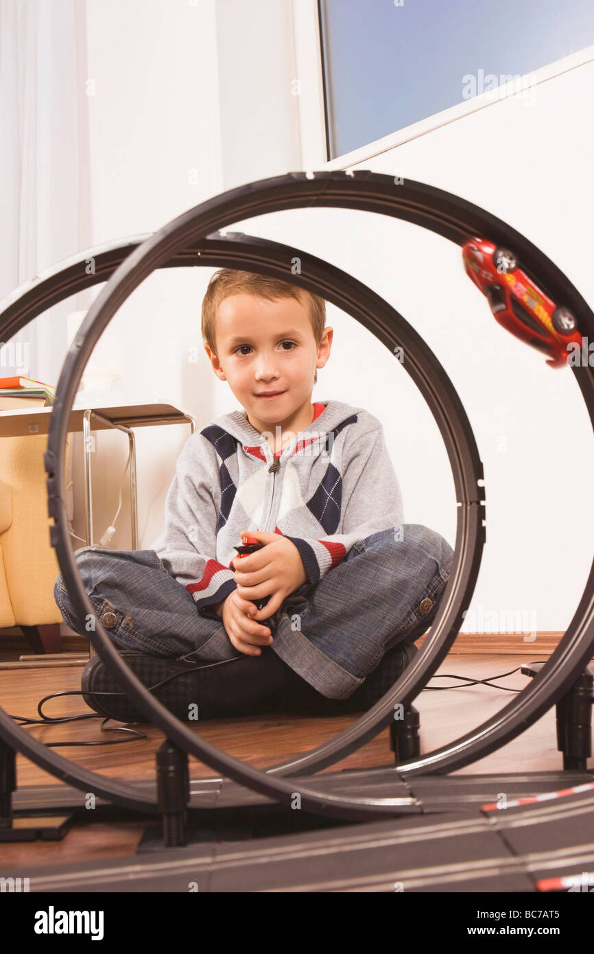 Boy (4-5) playing with toy racetrack Stock Photo