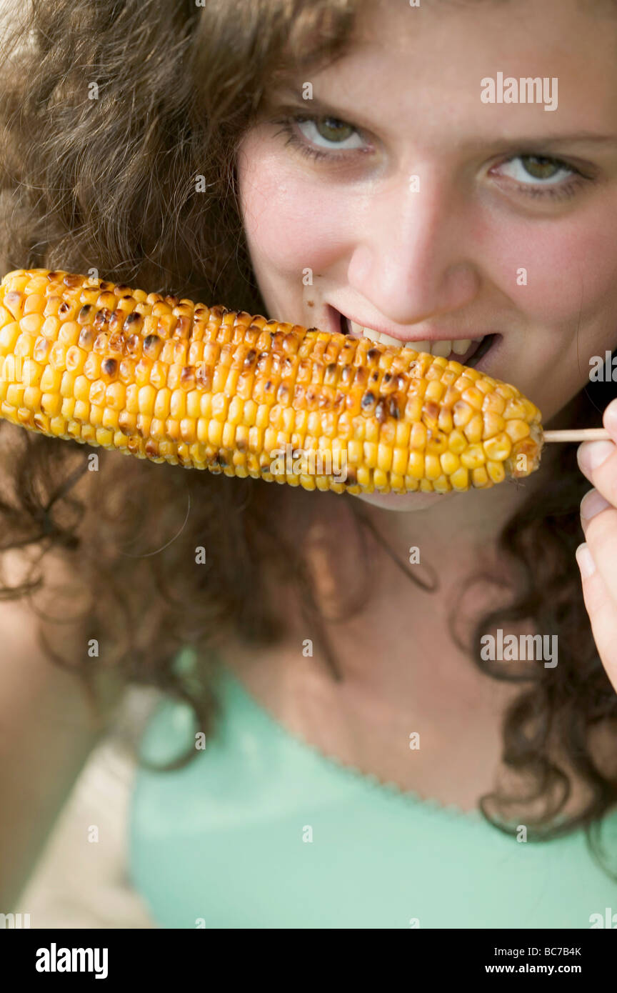 Woman eating grilled corn on the cob Stock Photo Alamy