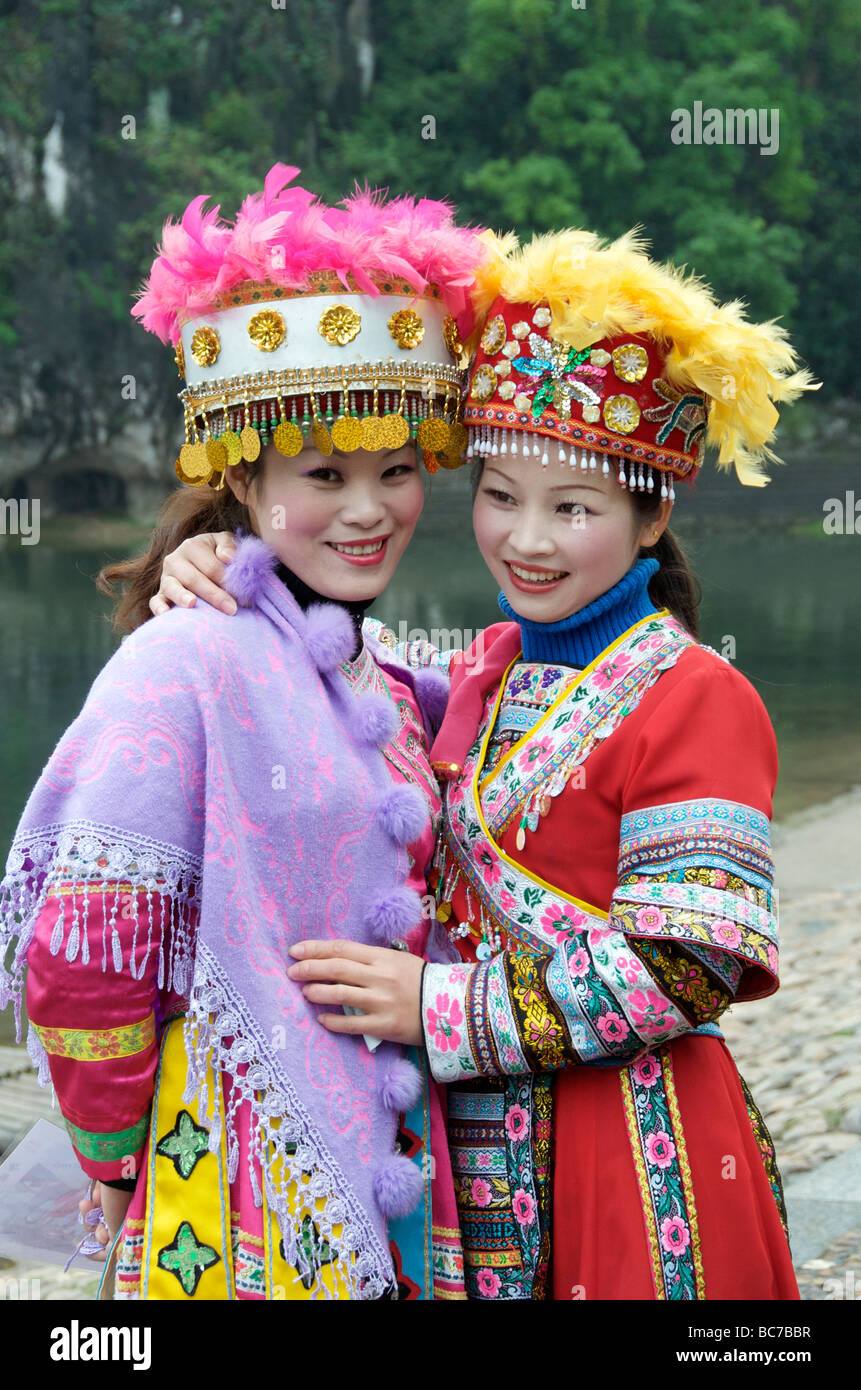 Two models posing in minority costume Guilin Guangxi China Stock Photo