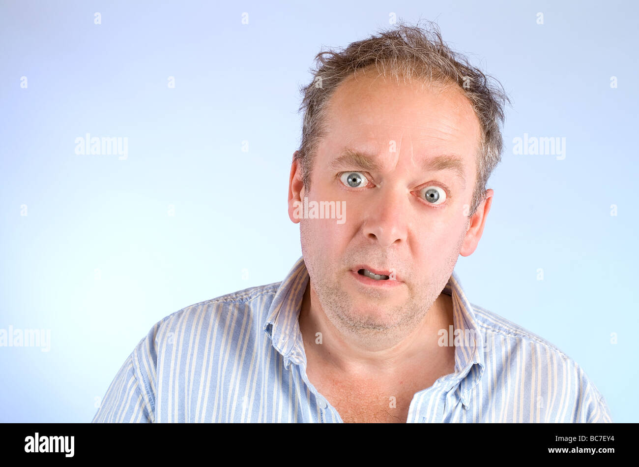 Serious and scruffy looking man posing and looking at the camera Stock Photo