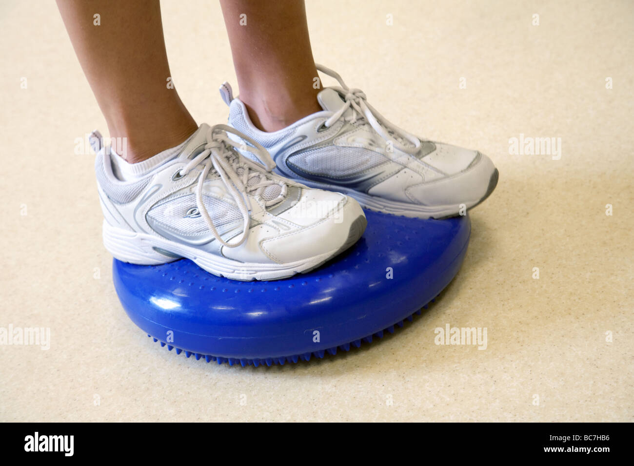Close up of person exercising on a wobble cushion Stock Photo