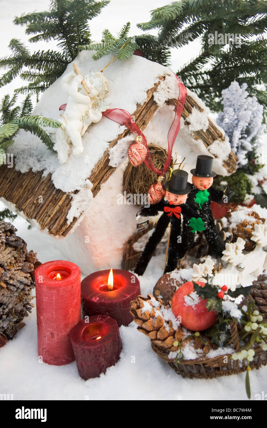 Christmas decorations and two chimney sweeps in snow - Stock Photo