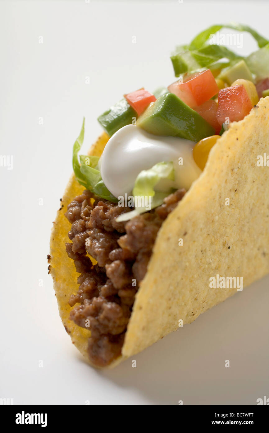 Taco filled with mince, lettuce, avocado and sour cream Stock Photo Alamy