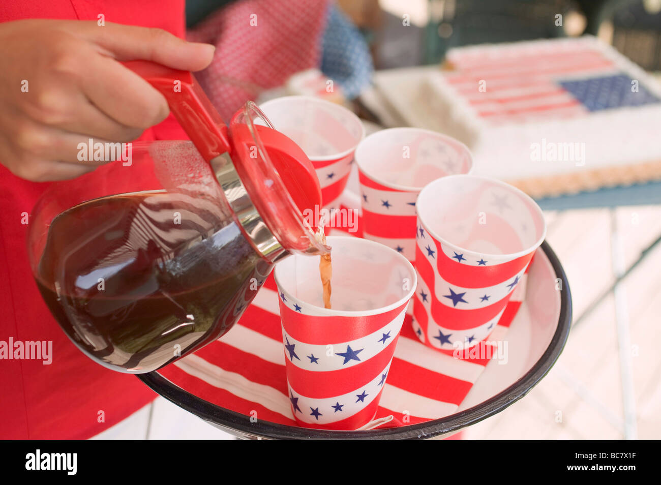 Woman pouring coffee into a paper cup (4th of July, USA Stock Photo - Alamy