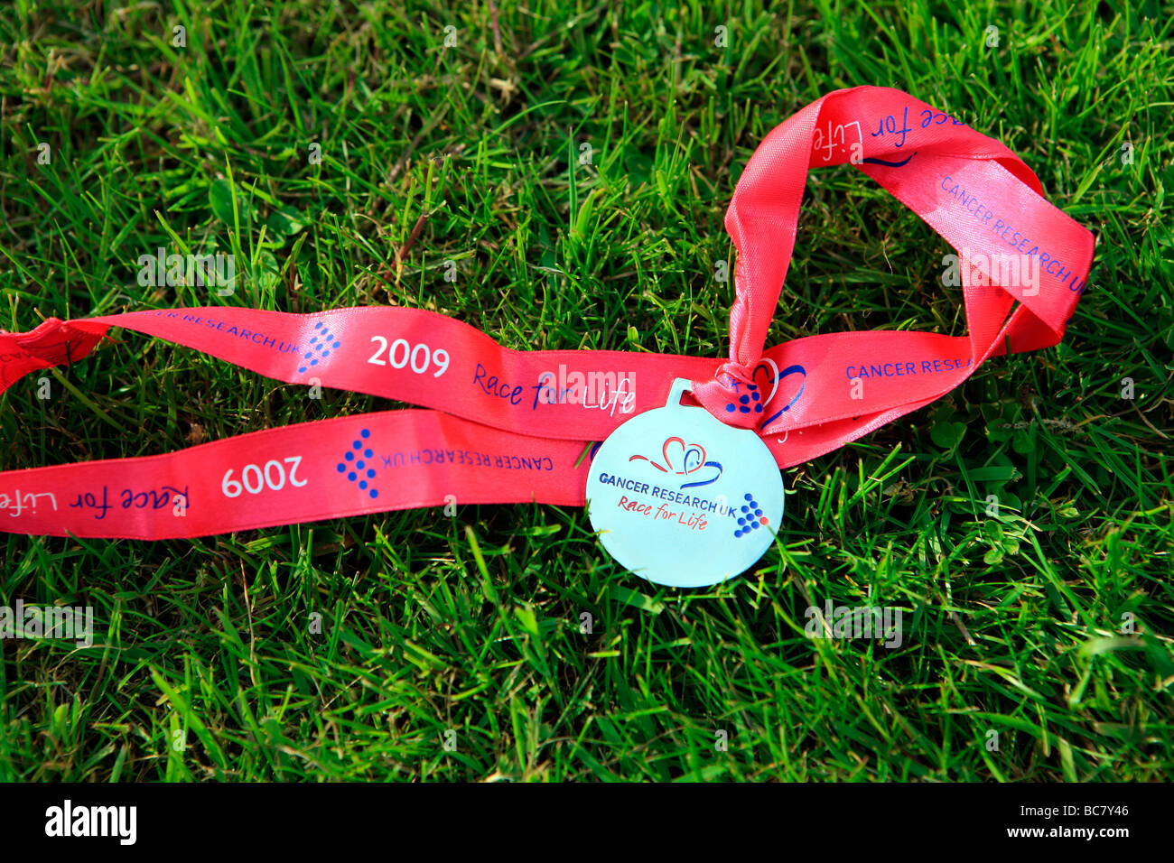 Race for life medal lying on grass Stock Photo Alamy