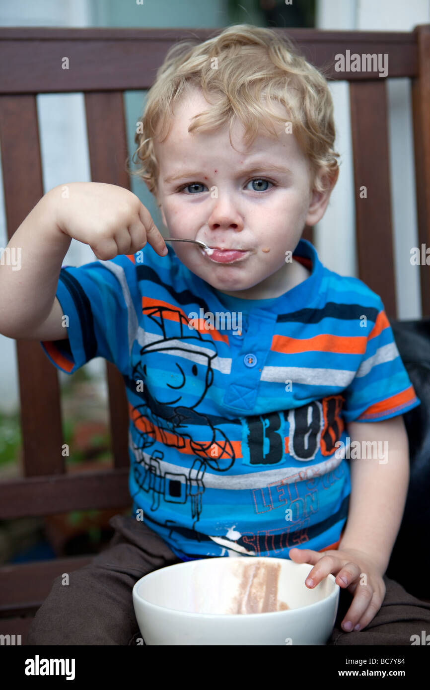 Toddler eating icecream from a bowl with spoon Stock Photo Alamy
