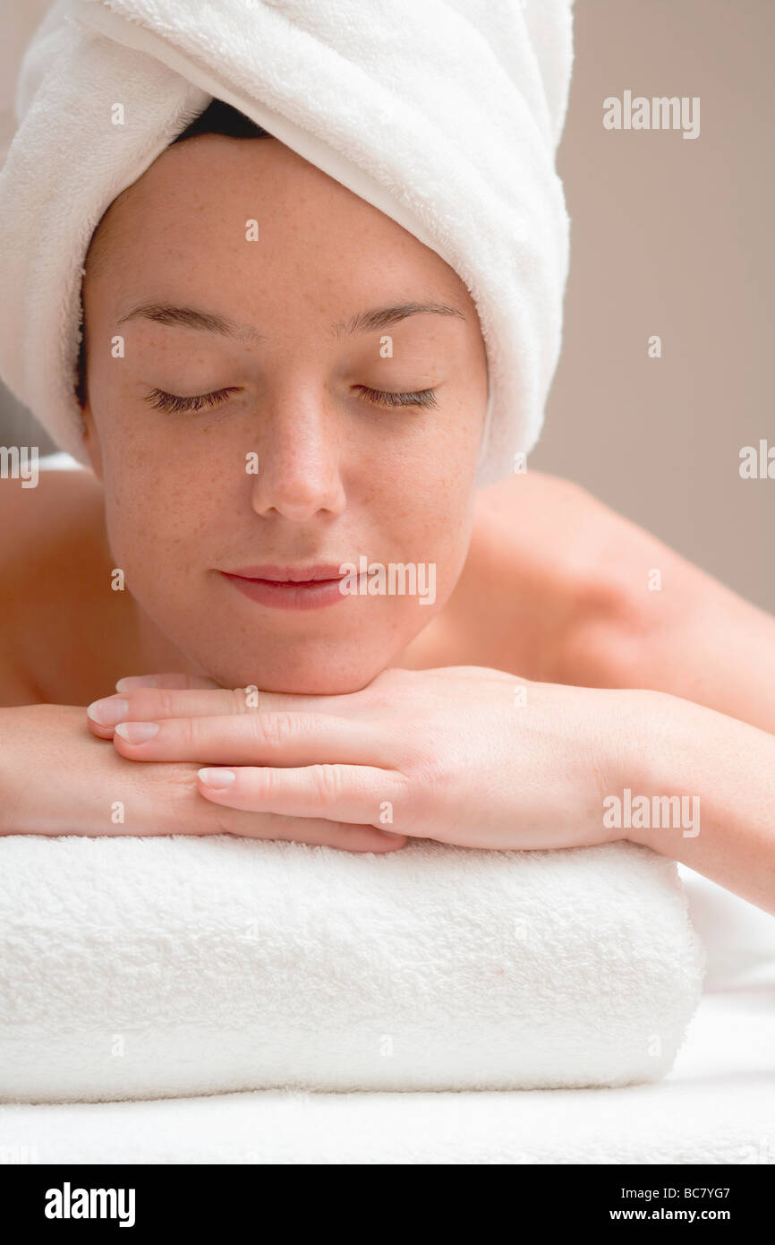 Woman lying down, resting on white towel Stock Photo Alamy
