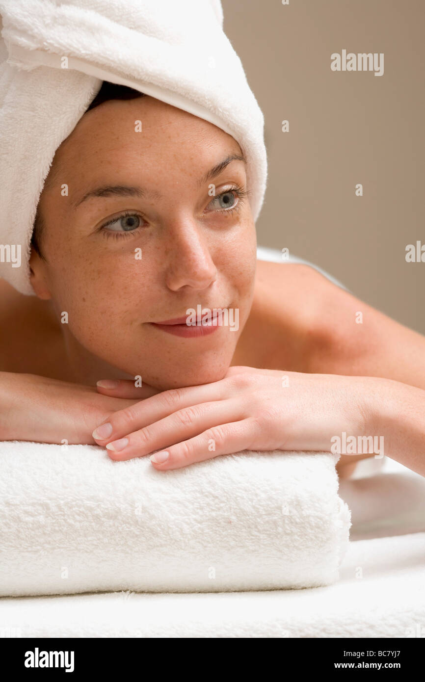 Woman lying down, resting on white towel Stock Photo Alamy