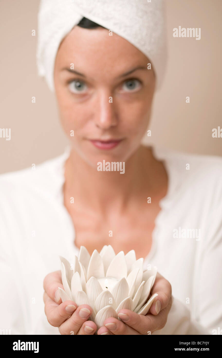 Woman holding water lily votive - Stock Photo