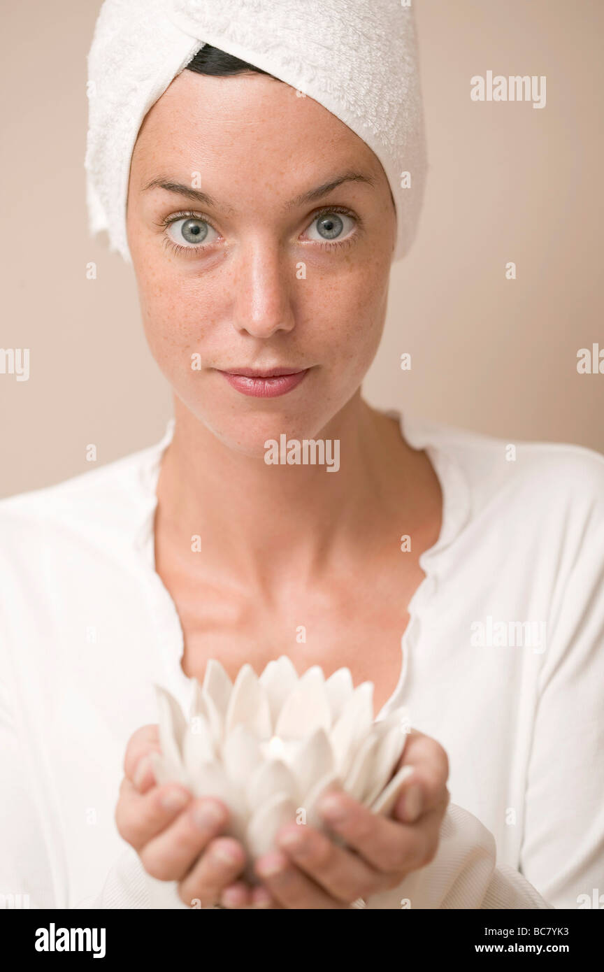 Woman holding water lily votive - Stock Photo