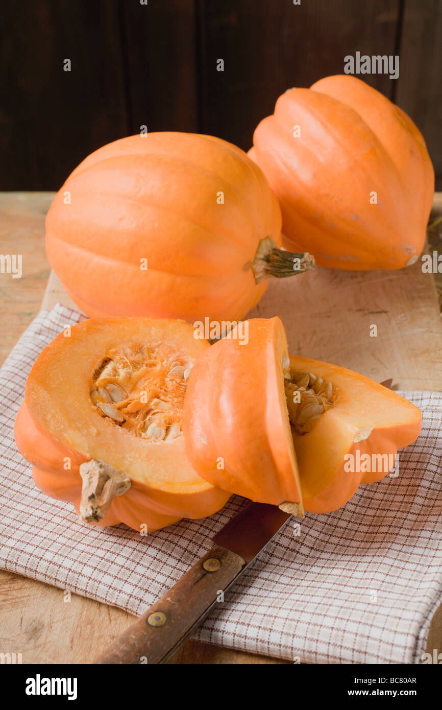 three-squashes-one-cut-into-pieces-stock-photo-alamy