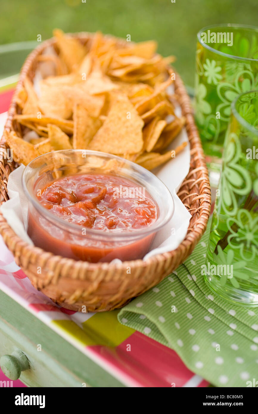 Tortilla chips and salsa on garden table Stock Photo Alamy